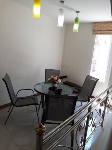 a dining room with a table and chairs at Uncle House Krabi in Krabi town