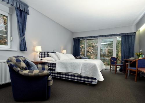 Postel nebo postele na pokoji v ubytování Hotel Břízky