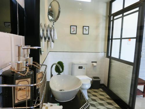 a bathroom with a sink and a toilet at Bloom Boutique Hotel & Cafe in Vientiane