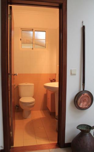 a bathroom with a toilet and a sink at Vila Da Praia in Campo de Baixo