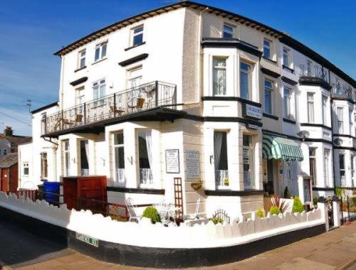 a large white building sitting next to a river at The Chequers in Great Yarmouth