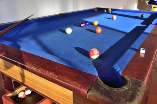 a blue pool table with balls on it at Blue Star Hotel in Melgar