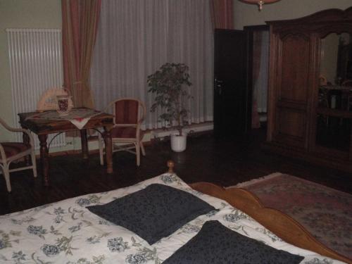 a bedroom with a bed and a table with a dining room at Schlosshotel Bredenfelde in Bredenfelde