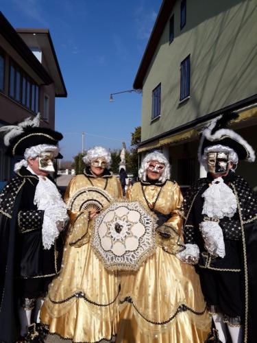 a group of people dressed in costumes holding an umbrella at Eureka Azienda Agrituristica in Cavallino-Treporti