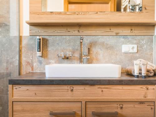 a bathroom with a sink on a counter at Chavida Chalets in Schattwald