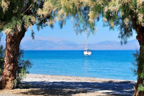 a boat in the middle of a large body of water at Great Greece Le Convivial Suites in Xylokastron