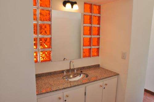a bathroom with a sink and a mirror at Las Artes Lodge in Mina Clavero