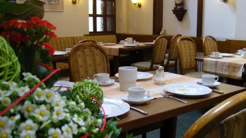 a table with cups and saucers on it in a restaurant at Hotel Lamm in Ostfildern