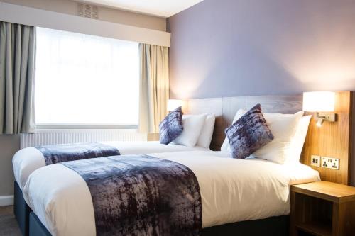 a hotel room with two beds and a window at Toby Carvery Doncaster by Innkeeper's Collection in Doncaster