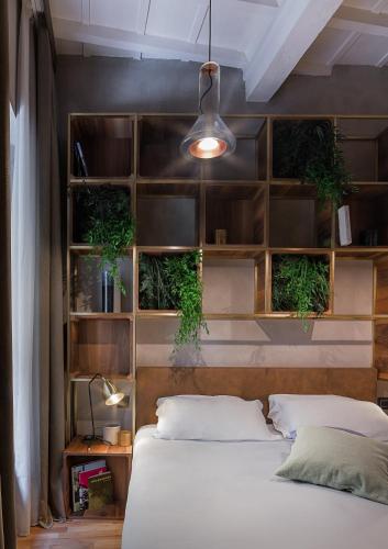 a bedroom with two beds and shelves with plants at Benci House in Florence