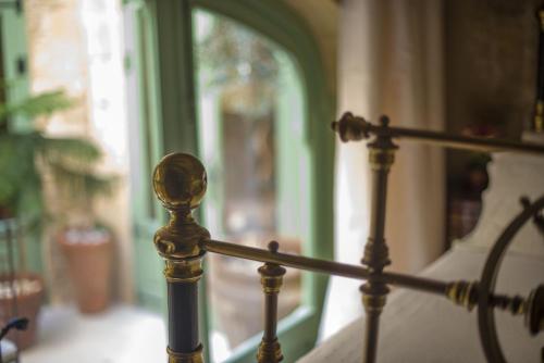 a close up of a metal railing in front of a window at The Burrow Guest House in Tarxien