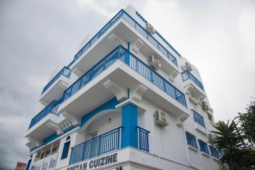 a white and blue building with blue railing at Sea View Apartments in Agios Nikolaos