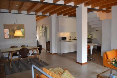 a living room and kitchen with a table and chairs at Appartamento vicinanze Vittoriale - Gardone Riviera in Gardone Riviera