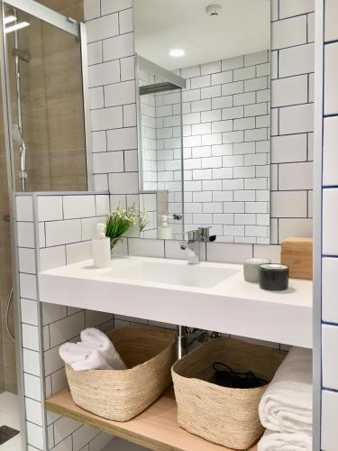 a bathroom with a sink and a mirror at Inside Bilbao Apartments in Bilbao