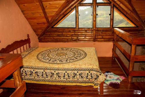 a bedroom with a bed in a cabin at Chalés Kayoá in Córrego do Bom Jesus