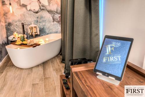 a tablet computer sitting on top of a counter in a bathroom at La Spezia by The First - Luxury Rooms & Suites in La Spezia