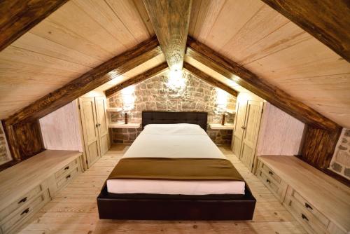 a bed in the middle of a room at Villa Dub in Kotor