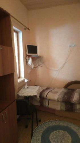 a room with a bed and a desk with a computer at Turul in Berehove