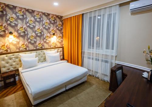 a hotel room with a bed and a window at Brown Hotel in Astana