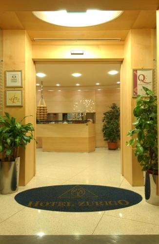 a lobby with a restaurant with a sign on the door at Hotel Zurigo in Varazze