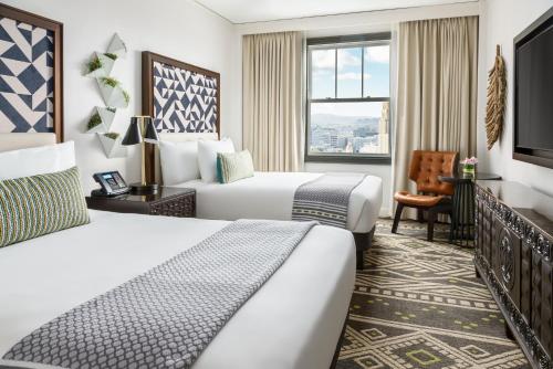 a hotel room with two beds and a window at Hotel Spero, Vignette Collection by IHG in San Francisco