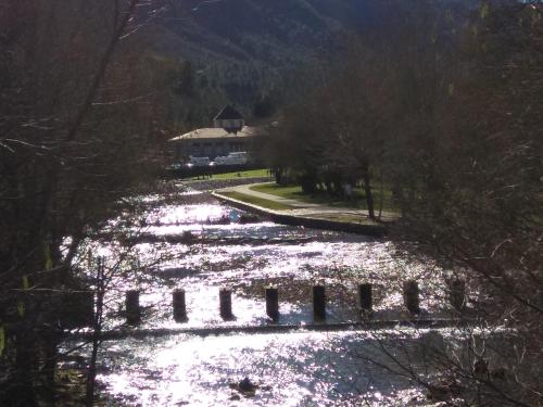 a river with a bridge in the middle of it at Secondary home in Lobios