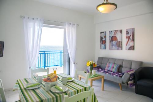 a living room with a couch and a table at Sea View Apartments in Agios Nikolaos