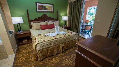 a hotel room with a bed with a towel on it at Mizner Place at Weston Town Center in Weston