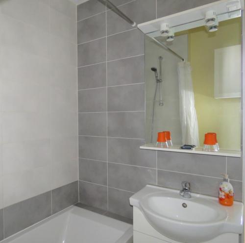 a bathroom with a sink and a mirror at Lodge MENDIA in Anglet