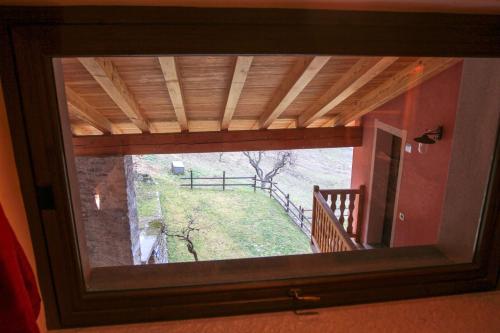 a window in a room with a view of a hill at La Maison De Deni in Aymavilles
