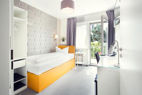 a hospital room with a bed and a sink at Hotel Löwenguth in Montabaur