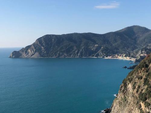 a view of a large body of water with mountains at Zia Letizia Bed And Wine in Monterosso al Mare