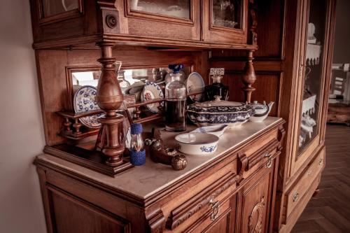 a wooden cabinet with dishes on top of it at Quinta Manel da Gaita in Torres Novas