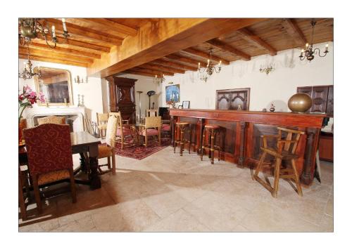 a living room with a table and a dining room at Chateau de Mauras in Chomérac