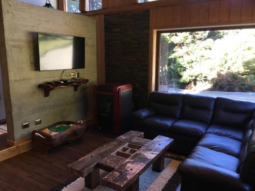 a living room with a couch and a table at Cabañas Peumayen in Puerto Varas