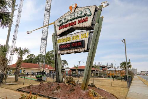 a sign for a burger cone club in a parking lot at Executive Inn - Panama City Beach in Panama City Beach