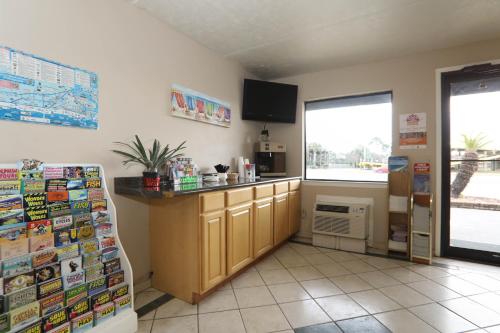 a kitchen with a counter and a refrigerator at Executive Inn - Panama City Beach in Panama City Beach