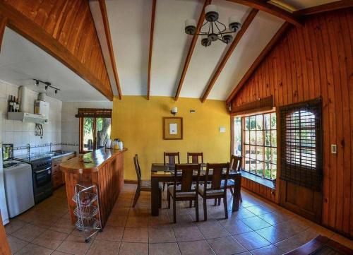 a kitchen with a table and a dining room at Cabañas del pillan in Pucón