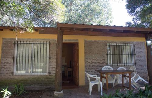 a table and chairs in front of a house at La Posada del Mar in Miramar