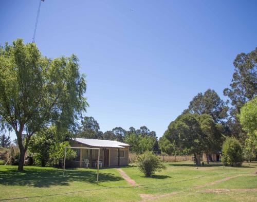 a house in the middle of a field with trees at La Posada del Mar in Miramar