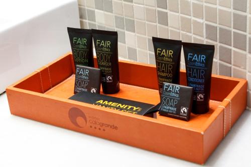 a box of four hair products on a shelf at Hotel Spa Calagrande Cabo de Gata in Las Negras