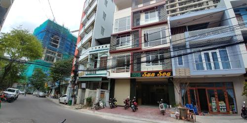 a city street with tall buildings with bikes parked on the sidewalk at Sun Sea Hotel in Quy Nhon