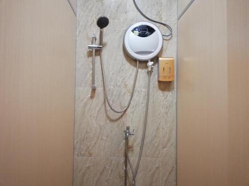 a shower in a bathroom with a shower head at Spacepod@SG in Singapore