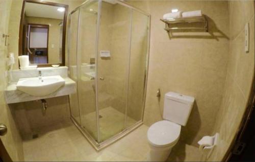 a bathroom with a shower and a toilet and a sink at MO2 Lagoon Coron in Coron