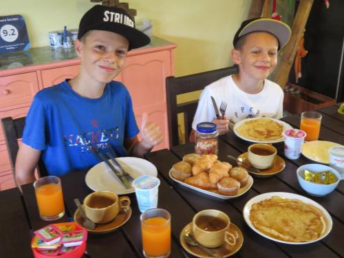 two young boys sitting at a table eating breakfast at Manora Garden in Phangnga