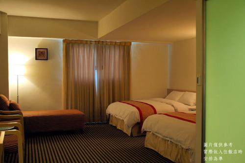 a hotel room with two beds and a window at Ocean Hayline Hotel in Jian