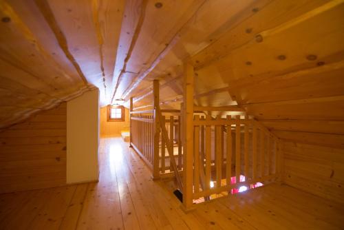 an empty room with a wooden staircase in a house at Drevenice TriMount in Liptovský Mikuláš