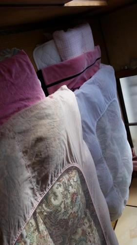 an unmade bed with a blanket on top of it at "Cherry House" is Direct to Narita,Haneda AP, Disney, Asakusa, Skytree Tower, Tokyo in Matsudo