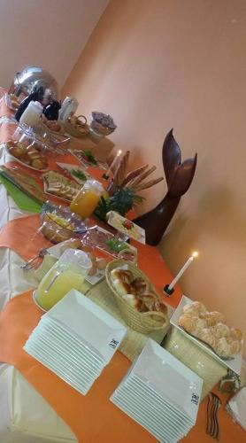 a table with a buffet of food on it at Hotel Vanivola & SPA in Sainte Marie