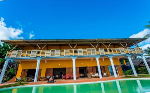 a house with a pool in front of it at Hotel Vanivola & SPA in Sainte Marie